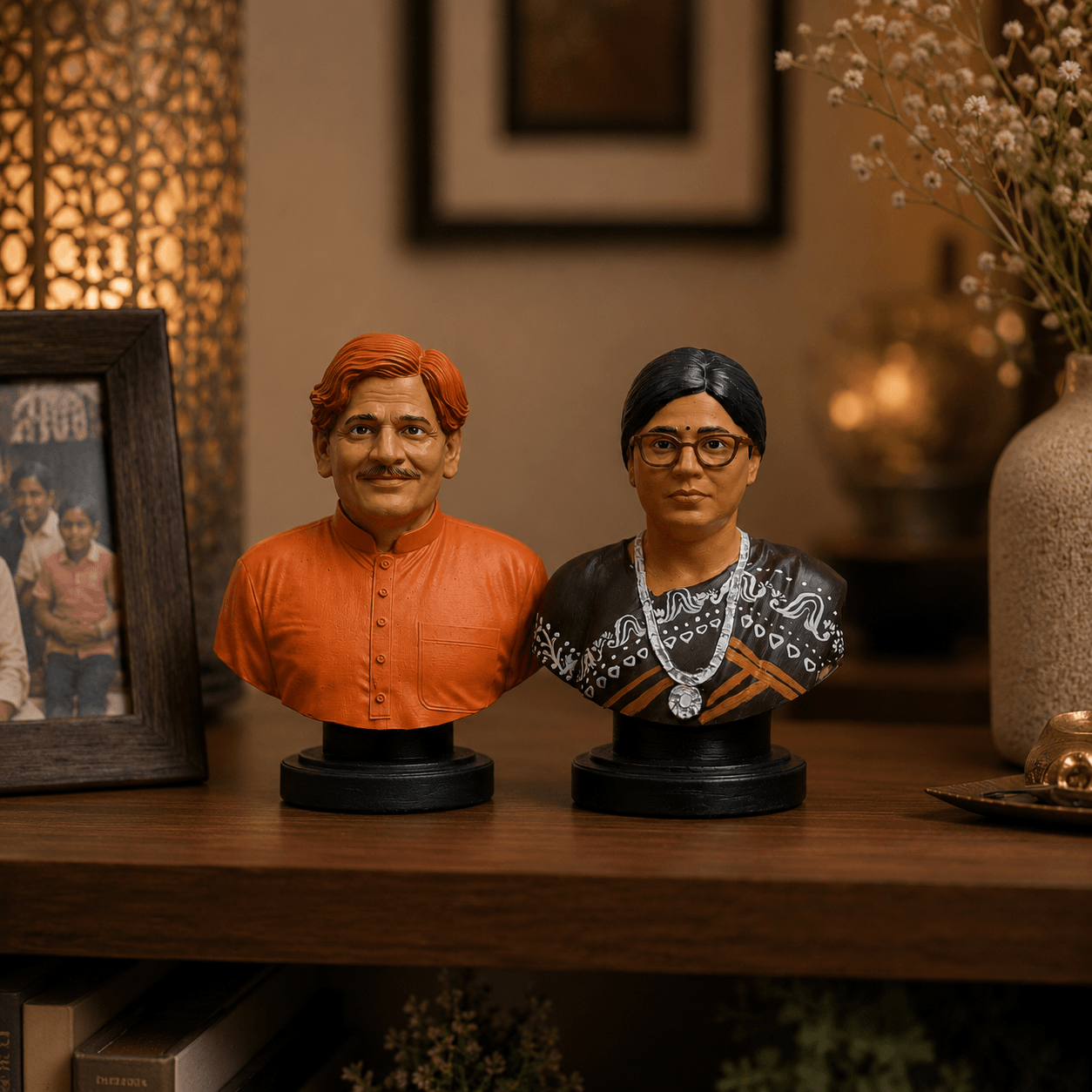 Two busts of a man and a woman on a wooden surface with a blurred background